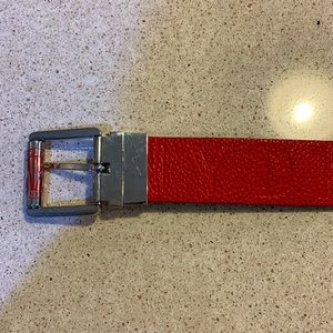 DKNY women’s red belt with DKNY embossed on the belt and silver buckle.